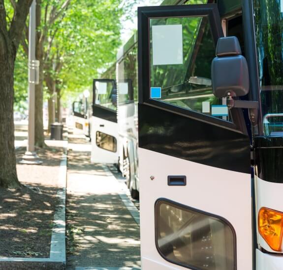 a charter bus parked at a curb